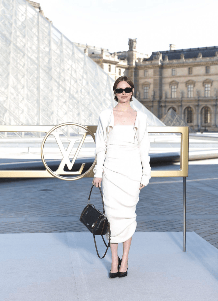 Emma Stone in a white draped dress at the Louvre