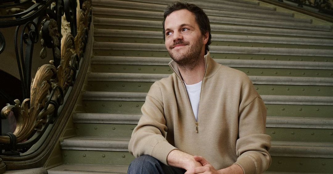 Matthieu Blazy seated on a staircase