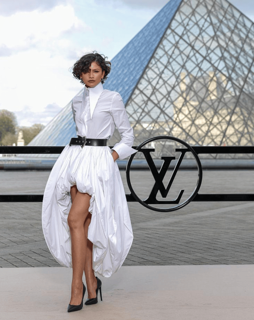 Zendaya in a white shirt and full skirt at the Louvre
